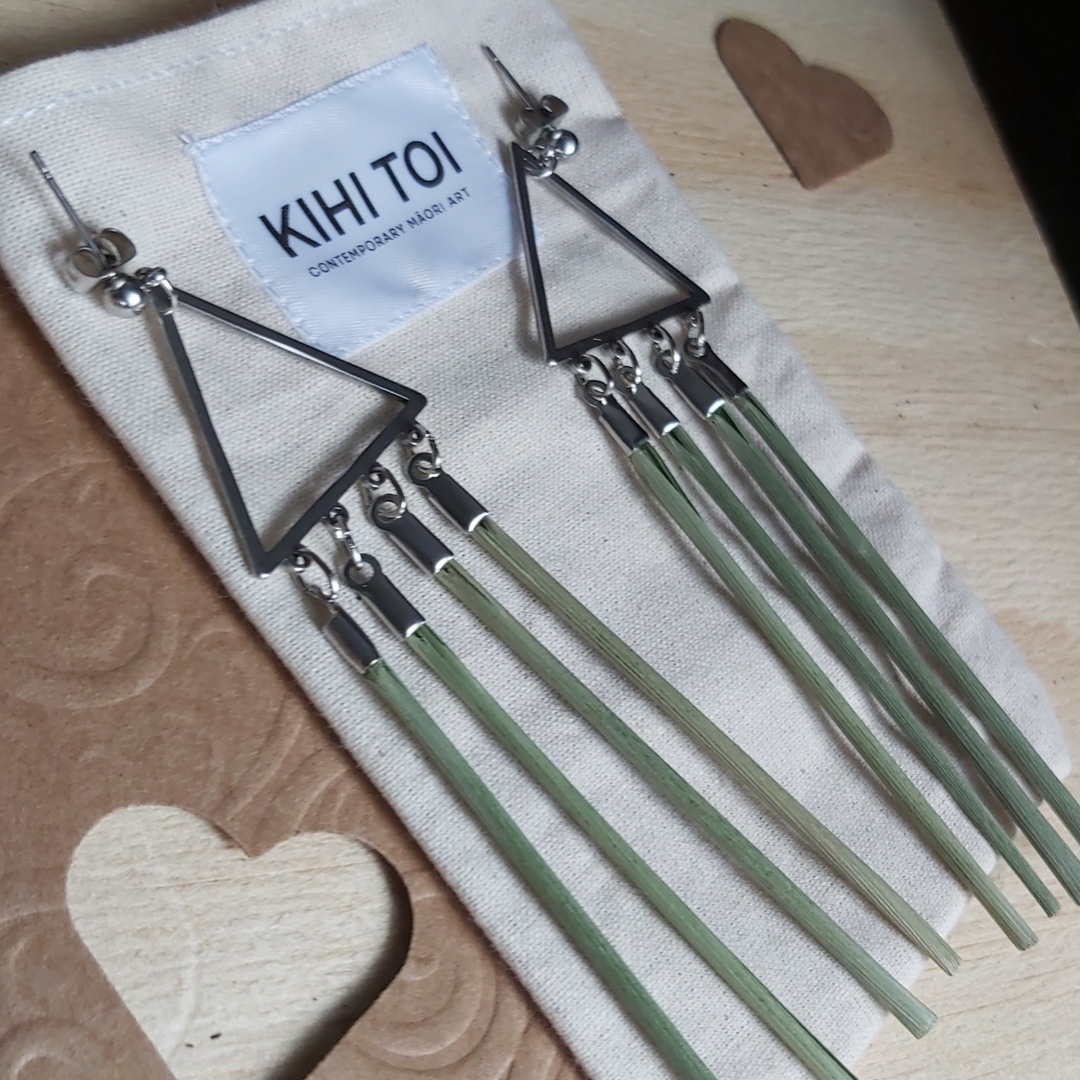 KIHI TOI Tīaho earrings. Stainless steel ear studs, stainless steel triangle chandelier, Four strands of wharariki nz flax. Flax strands approxiamtely 6.5cm in length